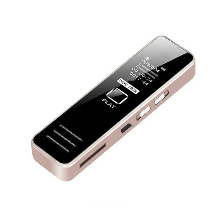 Small black or gold portable digital voice recorder with USB cable on a desk.