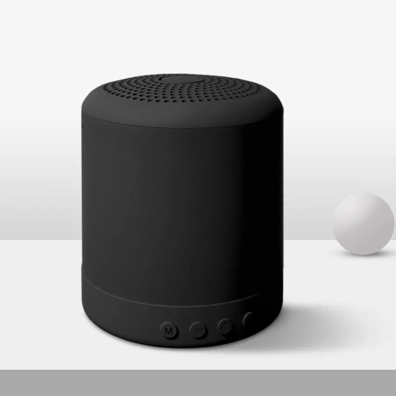 A11 compact wireless subwoofer speaker in black, pink, blue, or green colour on a desk.