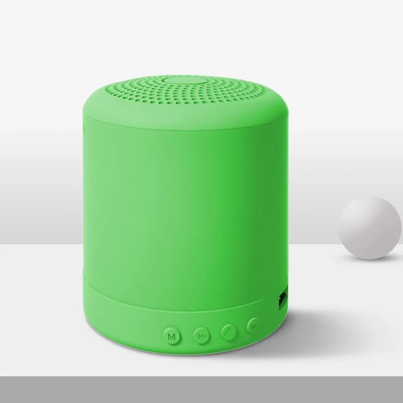 A11 compact wireless subwoofer speaker in black, pink, blue, or green colour on a desk.