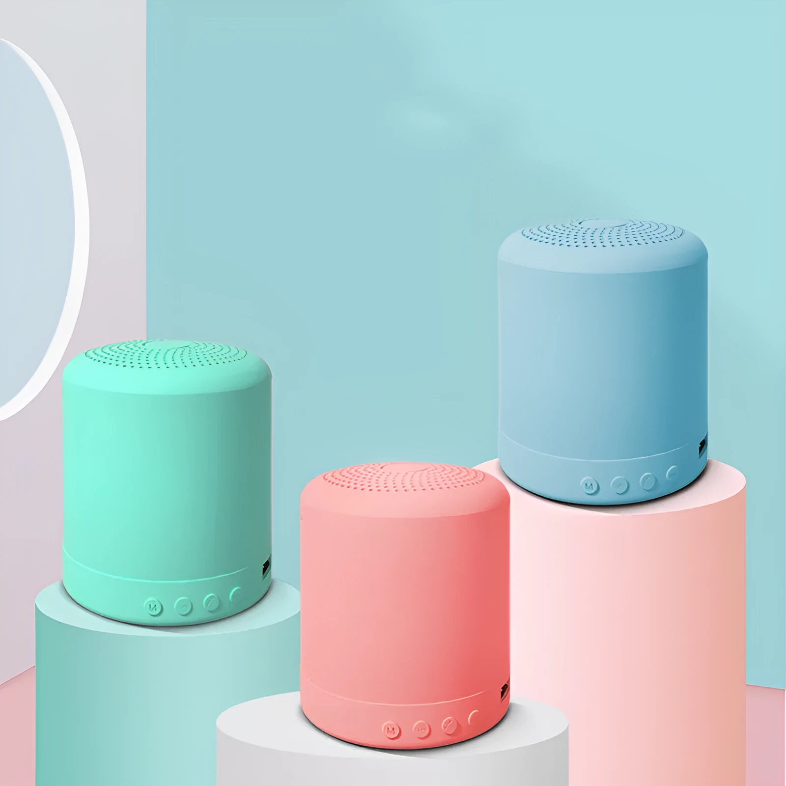 A11 compact wireless subwoofer speaker in black, pink, blue, or green colour on a desk.