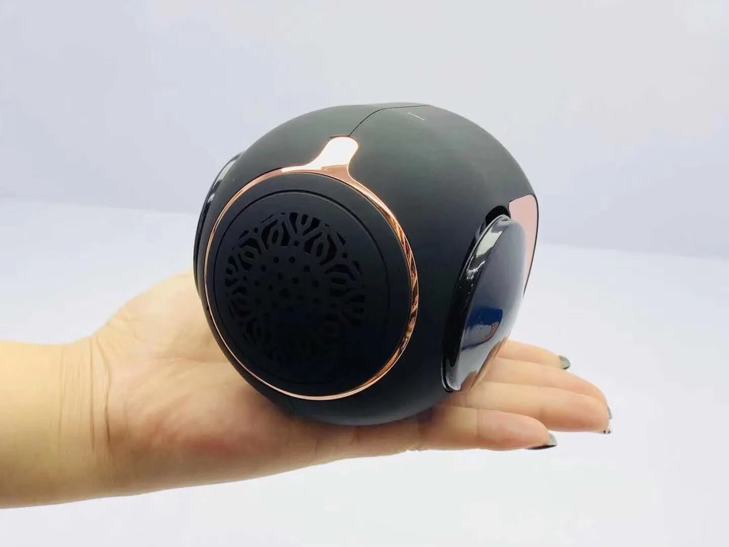 Small golden egg shaped wireless Bluetooth speaker in black, white or blue with compact portable design