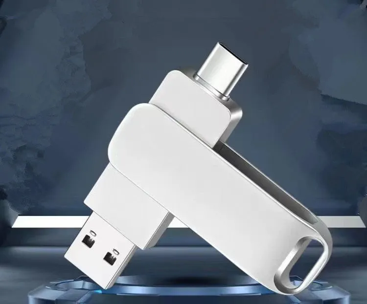 Rotating metal USB flash drive showing USB and USB-C connectors with black finish and protective iron box packaging