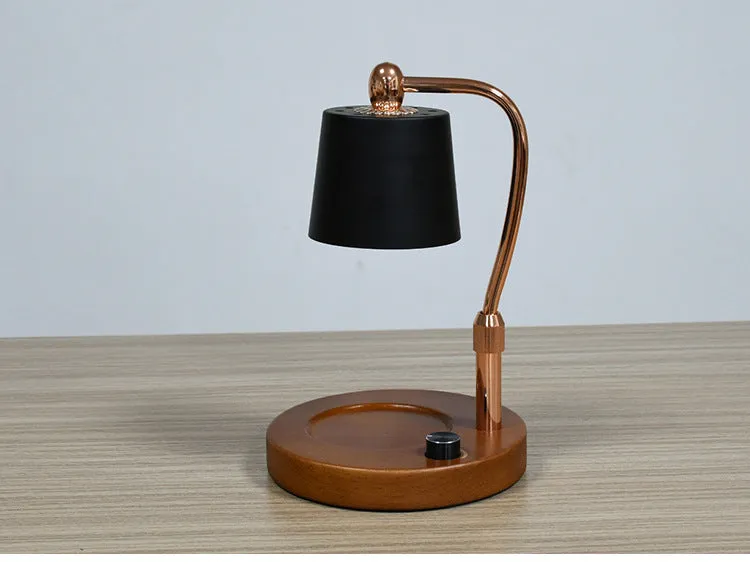 A black wooden aromatherapy wax lamp holding a candle on a bedroom surface.