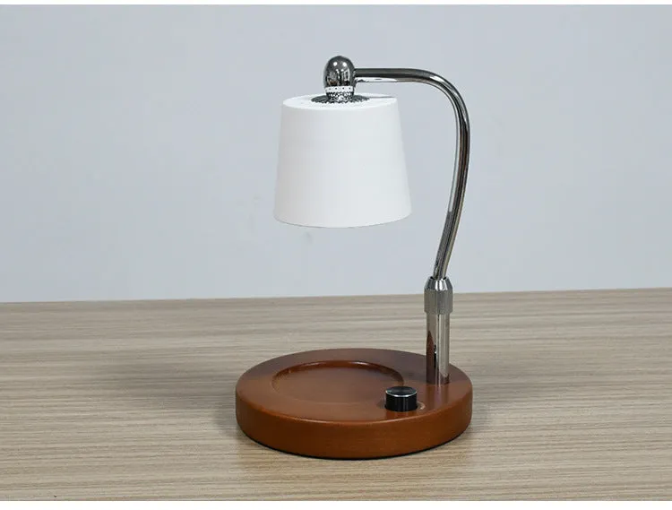 A black wooden aromatherapy wax lamp holding a candle on a bedroom surface.
