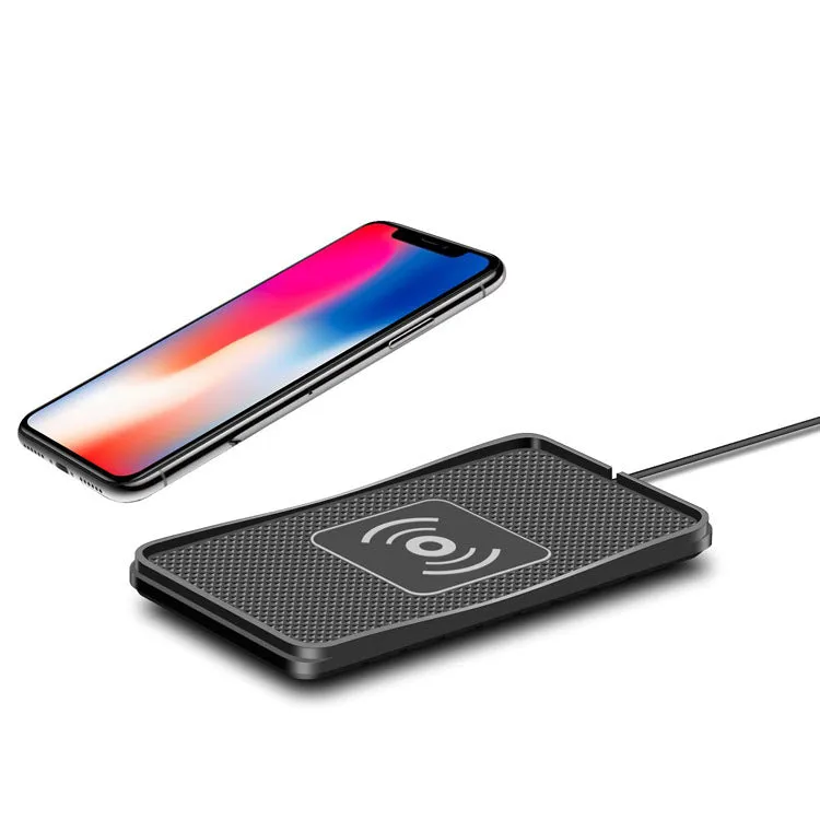 Black universal wireless car charger mount on a car air vent, charging a smartphone.