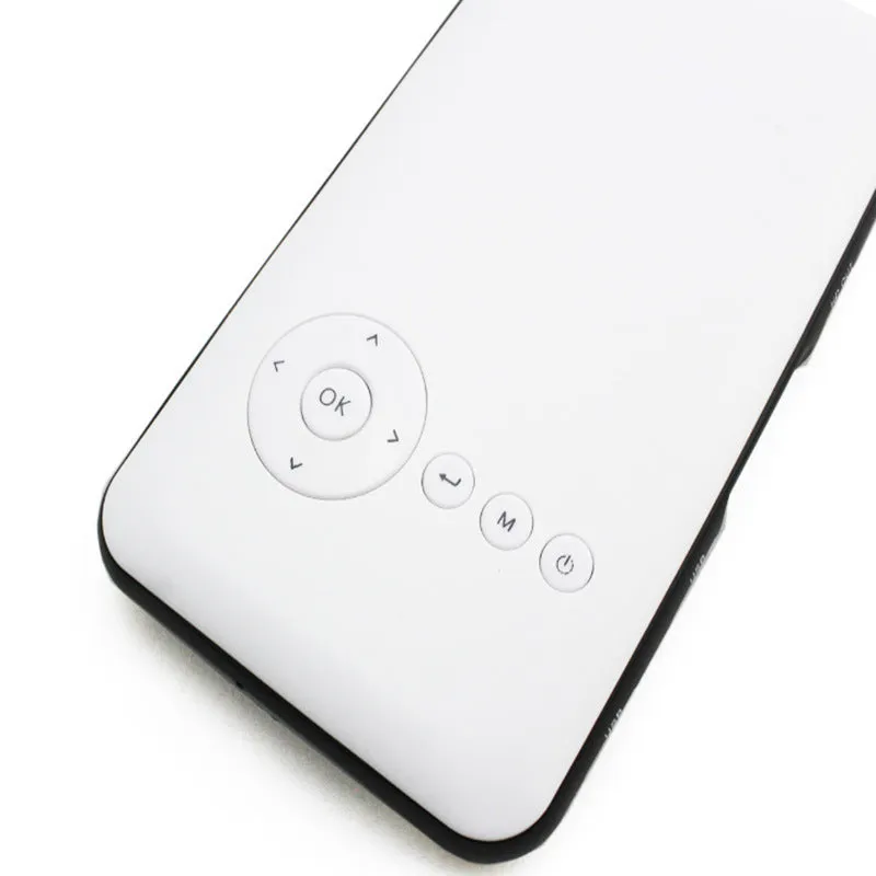 White smart handheld projector with Android system, DLP technology, wireless projection capability, placed on a table