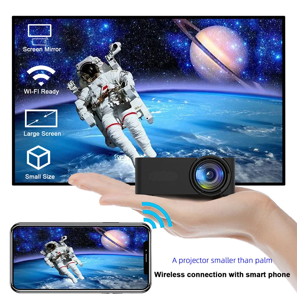 YT100 black mini portable projector on a desk with remote control and USB cable
