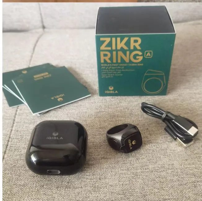 Zikr1 metal smart ring for Tasbih counting on a finger, showing its OLED display and single button.