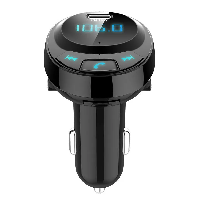 Black Bluetooth car MP3 charger with numeric display plugged into a car dashboard cigarette lighter.