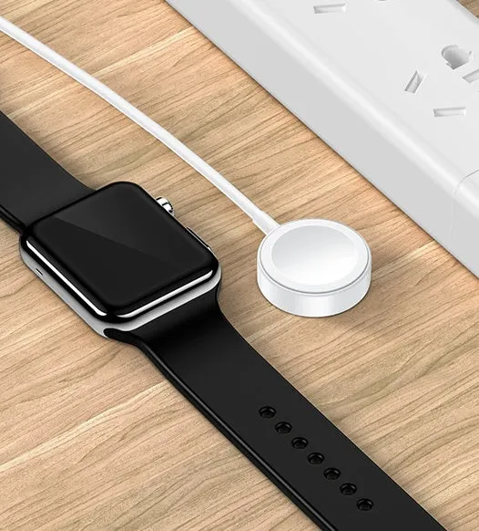White metal Apple Watch wireless charger with 1m USB cable on a table
