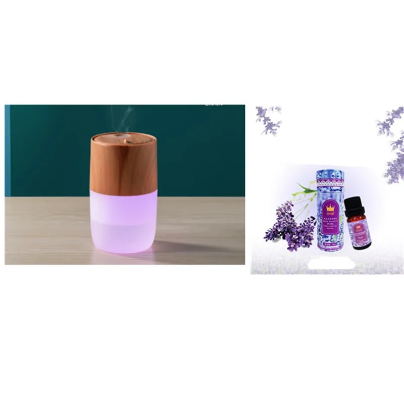 Mini portable jellyfish-shaped ultrasonic humidifier in black, with USB cable and essential oil bottle on a desktop