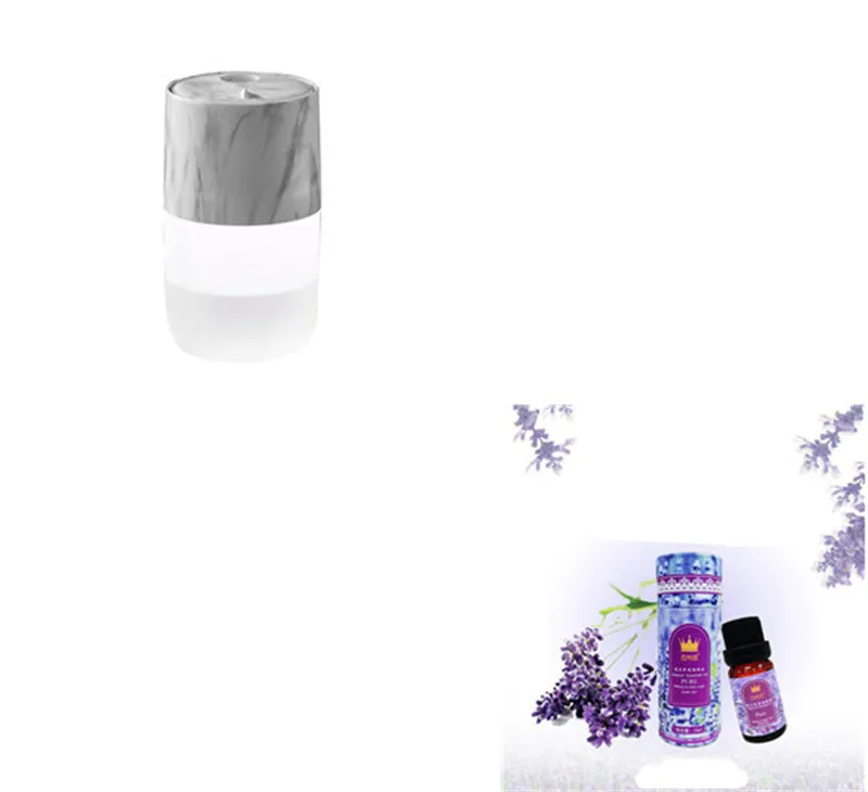 Mini portable jellyfish-shaped ultrasonic humidifier in black, with USB cable and essential oil bottle on a desktop