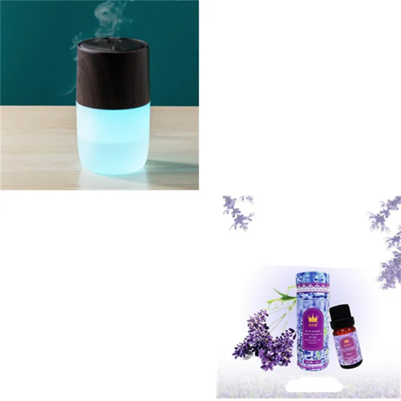 Mini portable jellyfish-shaped ultrasonic humidifier in black, with USB cable and essential oil bottle on a desktop