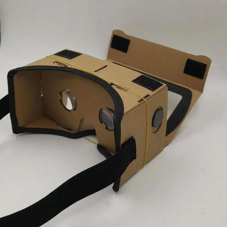 Foldable pink and white VR cardboard glasses headset for smartphones with adjustable strap and 3D lenses.