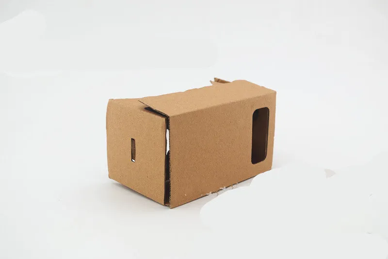 Foldable pink and white VR cardboard glasses headset for smartphones with adjustable strap and 3D lenses.