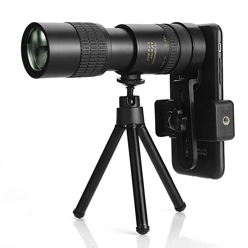Monocular 10-300x40 zoom telescope with telescopic tripod bracket and universal mobile phone clip on a table