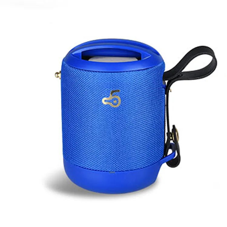 Compact black waterproof bluetooth speaker with portable belt on a table