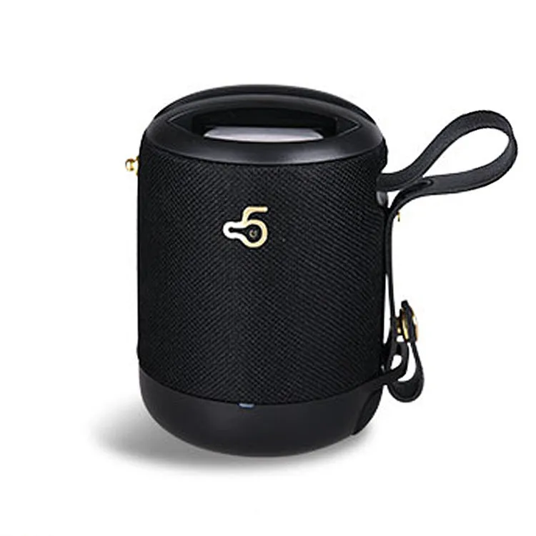 Compact black waterproof bluetooth speaker with portable belt on a table