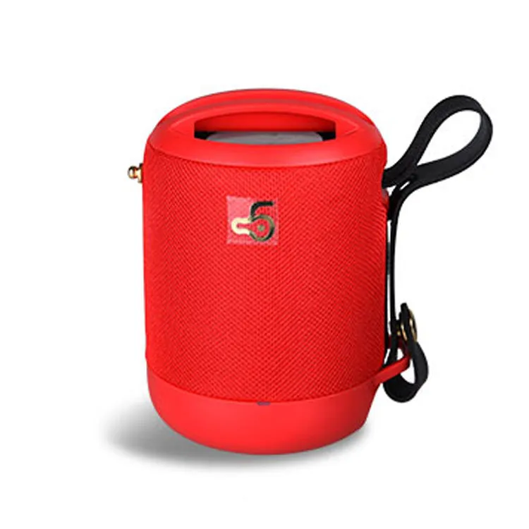 Compact black waterproof bluetooth speaker with portable belt on a table