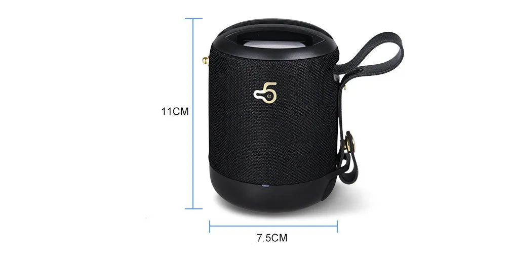 Compact black waterproof bluetooth speaker with portable belt on a table