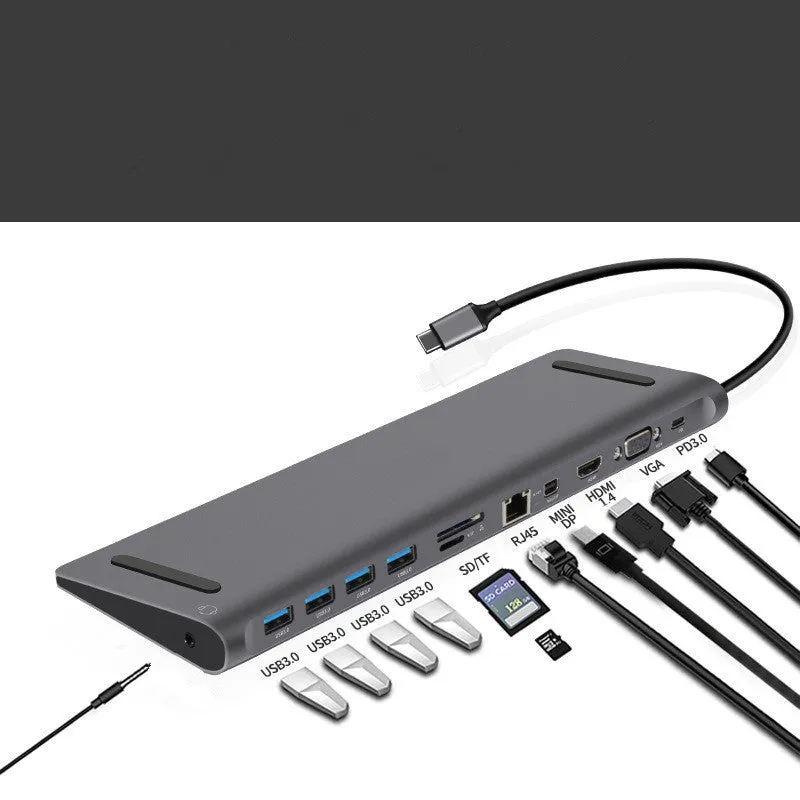 Grey aluminium alloy 12-in-1 Type-C hub with HDMI, VGA, USB 3.0, Ethernet, and PD ports on a desk