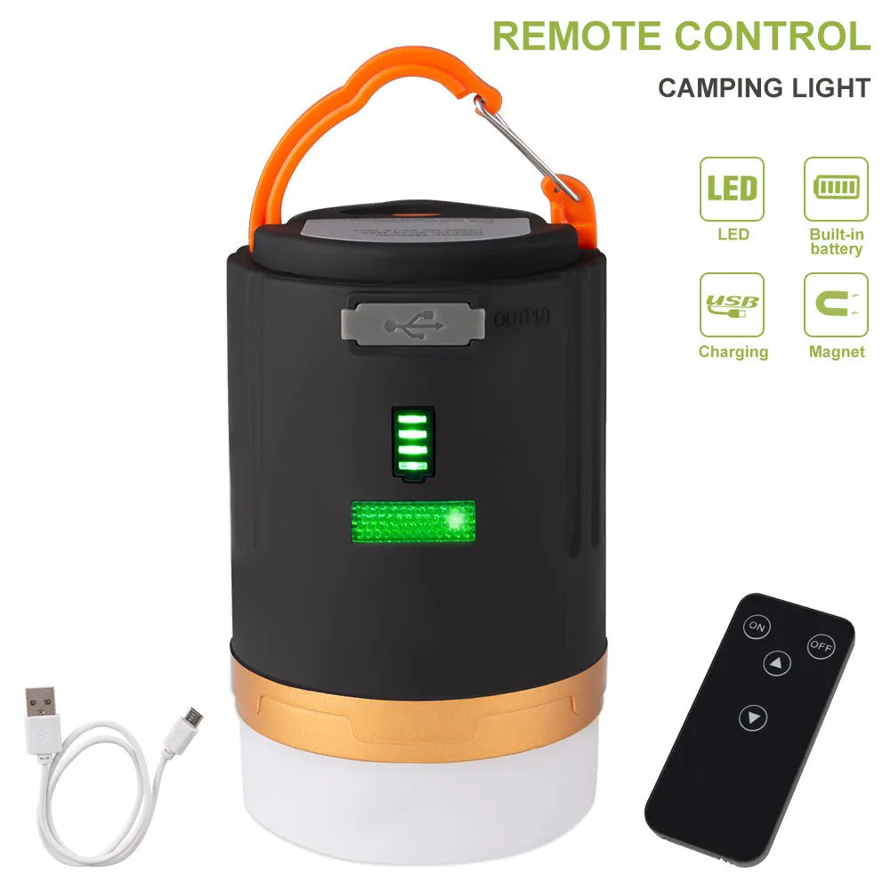 Black rechargeable LED camping light with hanging hook and remote control on a table
