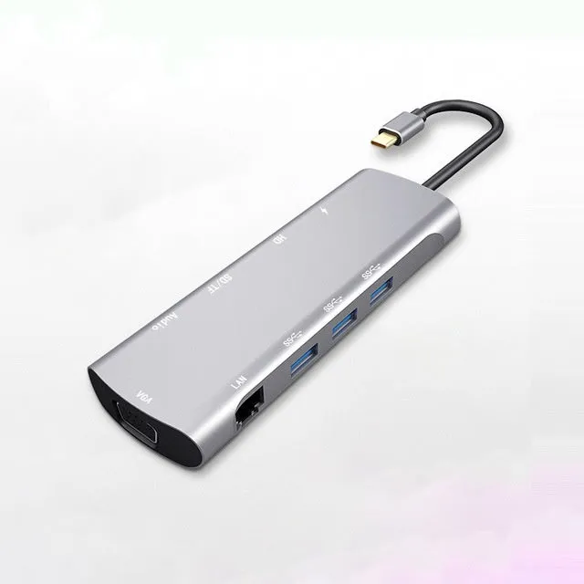 Grey aluminium USB-C docking station with multiple ports including HDMI, VGA, and USB, showing its 140mm attached cable.