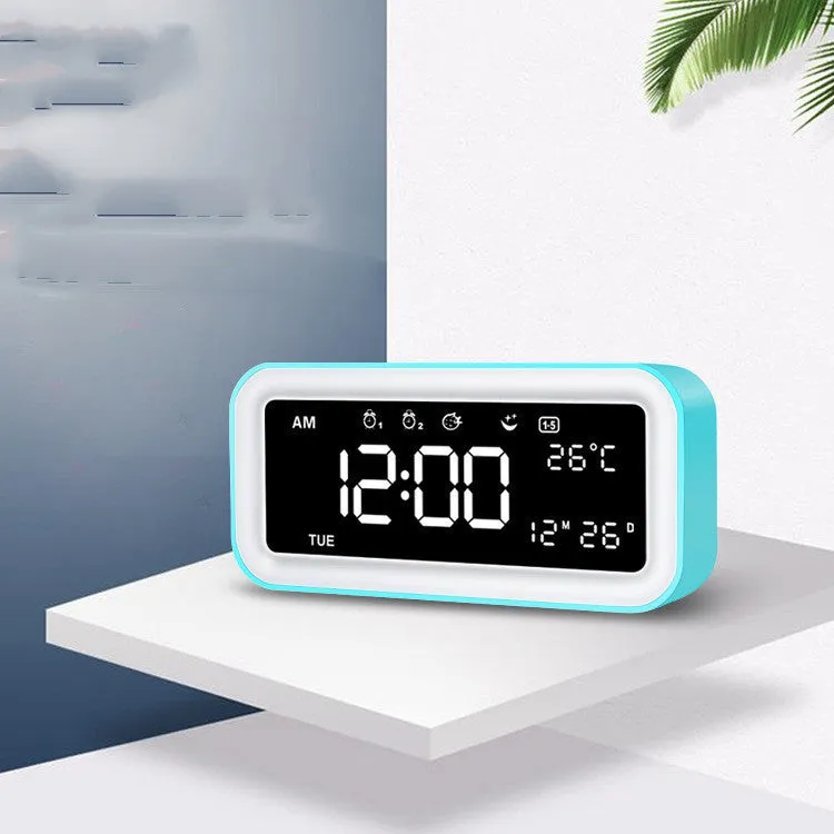 Blue rectangular LED alarm clock with digital display on a table.