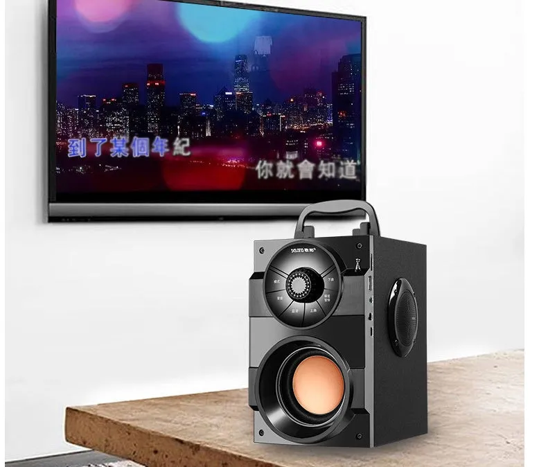 Black portable mini audio system with subwoofer and 3.5mm audio cable.