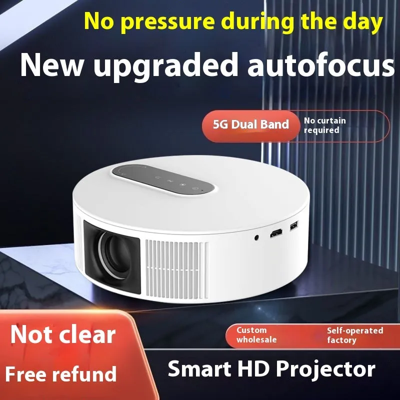 White HD home projector with remote control on table for bedroom cinema setup