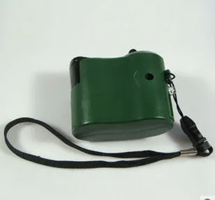 USB hand dynamo charger in green and blue showing winding handle and LED indicator