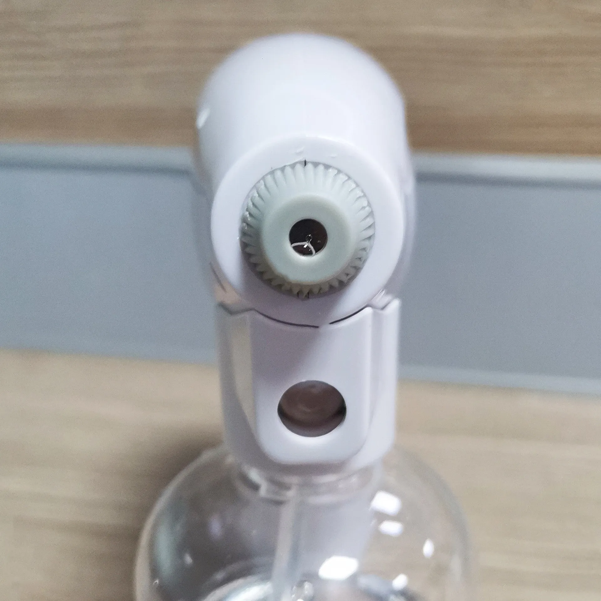 White handheld cordless electric spray gun with USB-C charging port on a plain background.