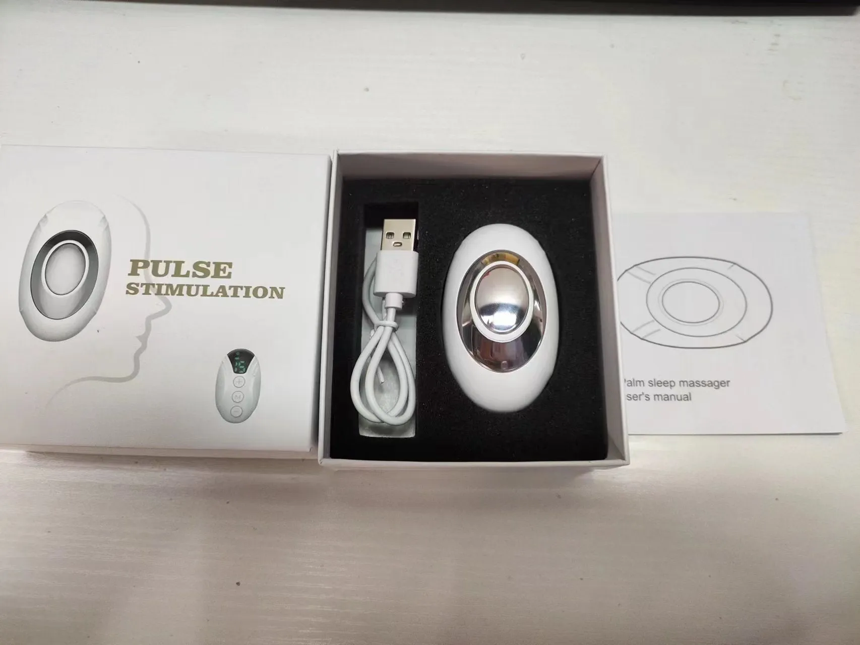 Intelligent charging hand-held pulse decompression insomnia help device in white with wireless remote control and USB cable