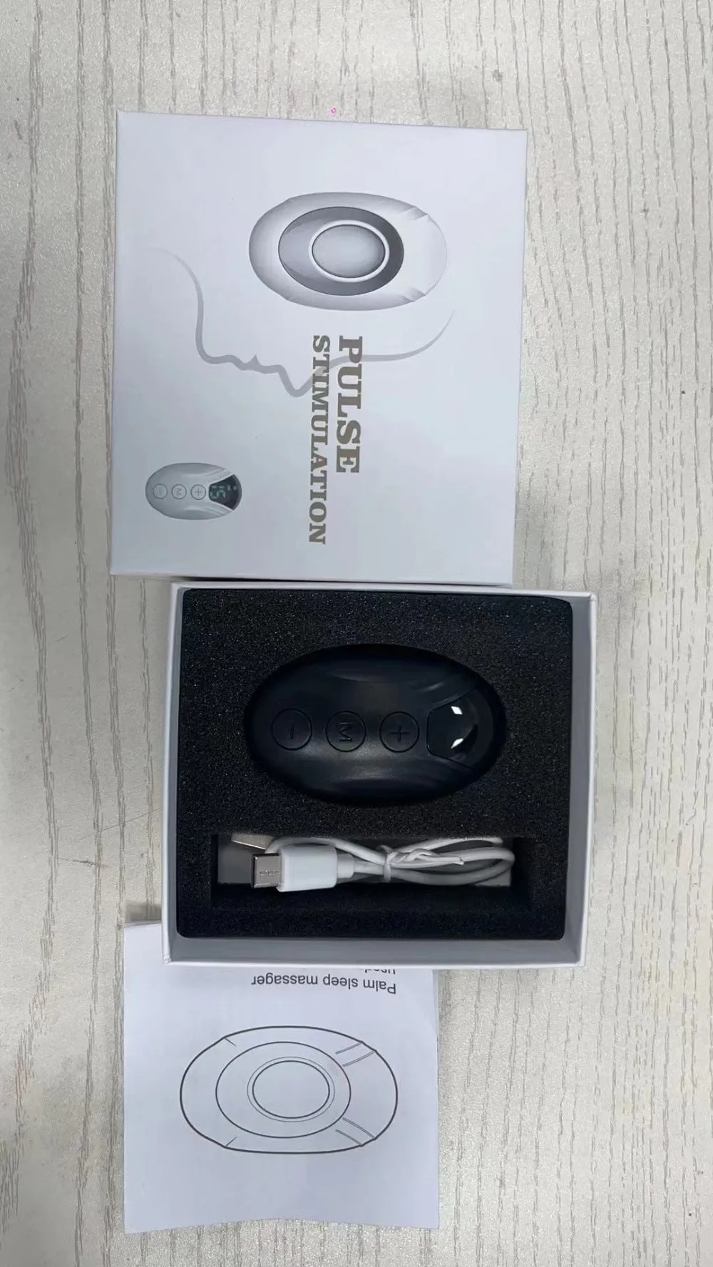 Intelligent charging hand-held pulse decompression insomnia help device in white with wireless remote control and USB cable