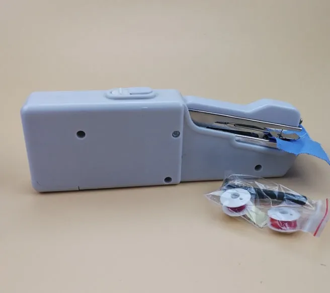 Handheld mini sewing machine set with thread spools, scissors, ruler, and clips in multiple colours