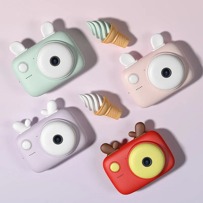 A2 Kids Macaron Mini SLR digital camera in pink, showing front and rear lenses and 2.4-inch screen.