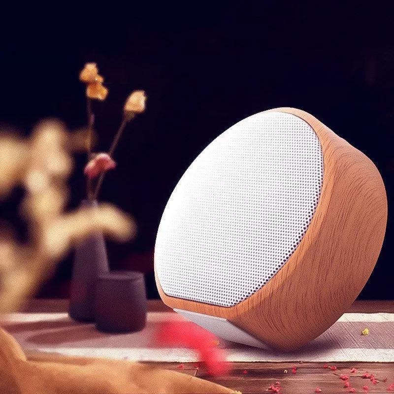 White wood grain Bluetooth speaker on a desk