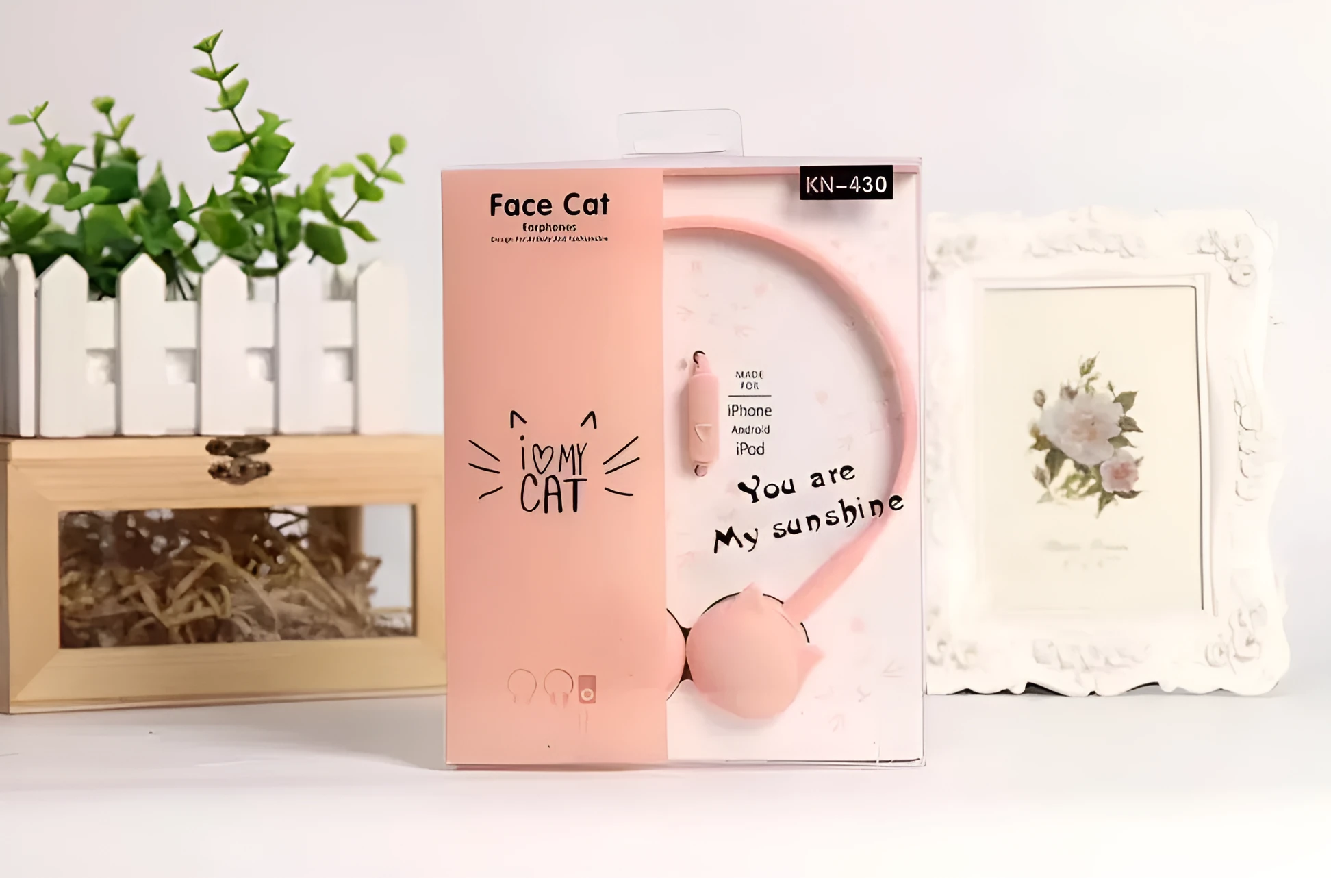 Kitten ear headphones in black with head-mounted design and 3.5mm plug on a desk next to a laptop.