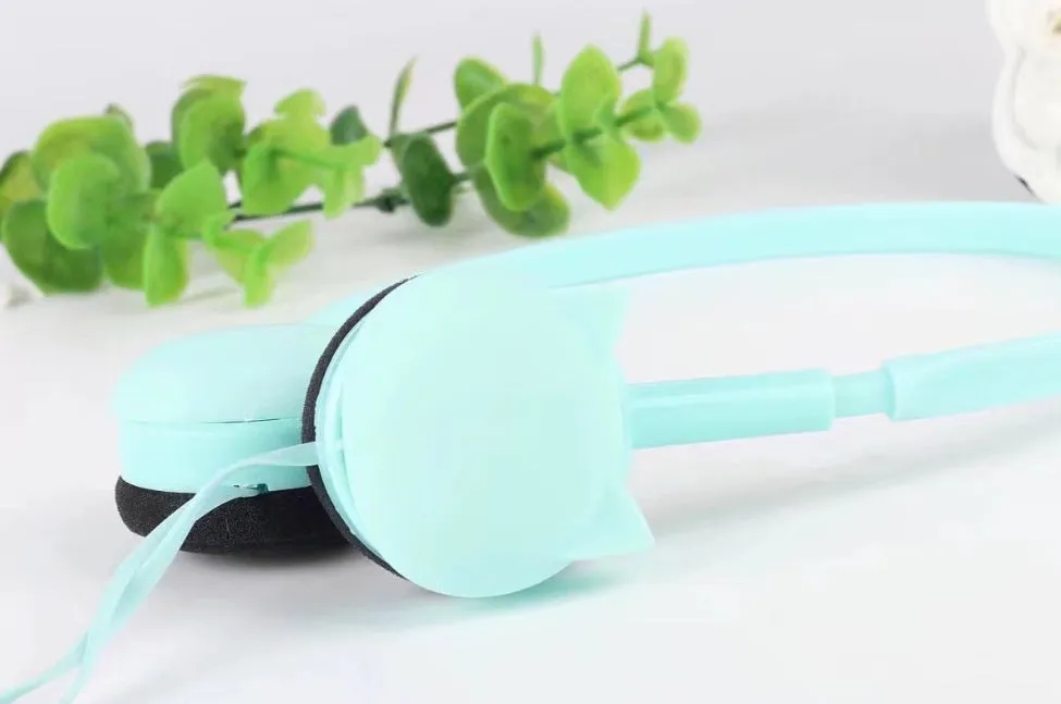 Kitten ear headphones in black with head-mounted design and 3.5mm plug on a desk next to a laptop.