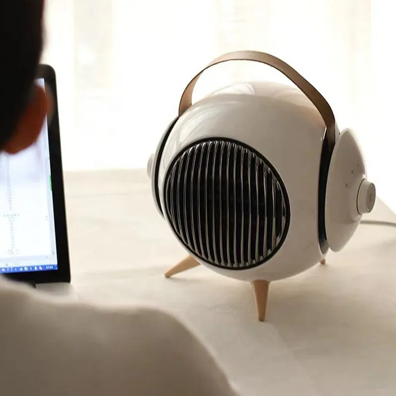 White household heater with shaking head and fine bottom fence on neutral background