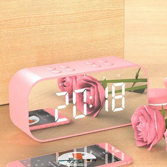 Wireless Bluetooth speaker with LED clock display showing time, black colour, compact ABS body on a desk