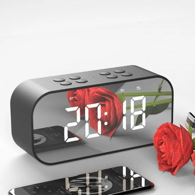 Wireless Bluetooth speaker with LED clock display showing time, black colour, compact ABS body on a desk