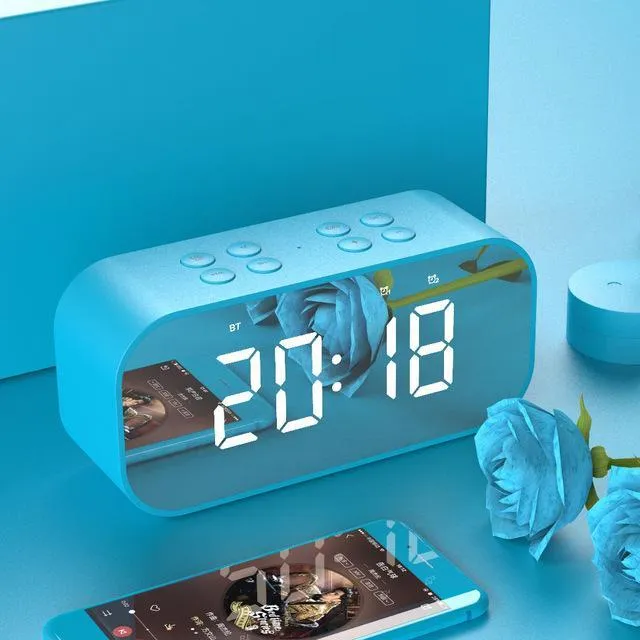Wireless Bluetooth speaker with LED clock display showing time, black colour, compact ABS body on a desk
