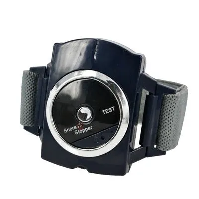 Black ABS anti snore wristband with biosensor and infrared therapy displayed on a flat surface