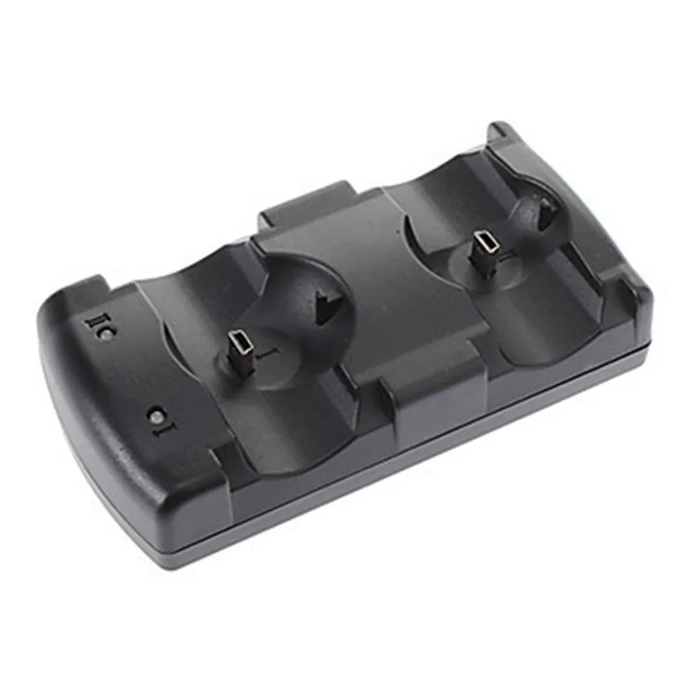 Black plastic dual USB charging dock for PlayStation 3 wireless controllers on a table.