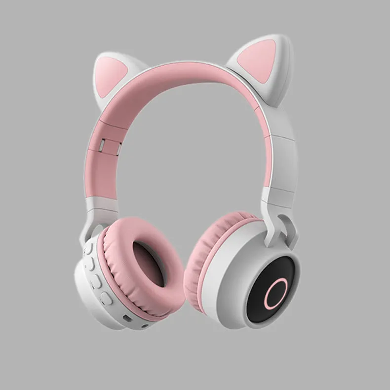 Cute Bluetooth 5.0 wireless headset in pink, foldable design with padded ear cups and 3.5mm audio port