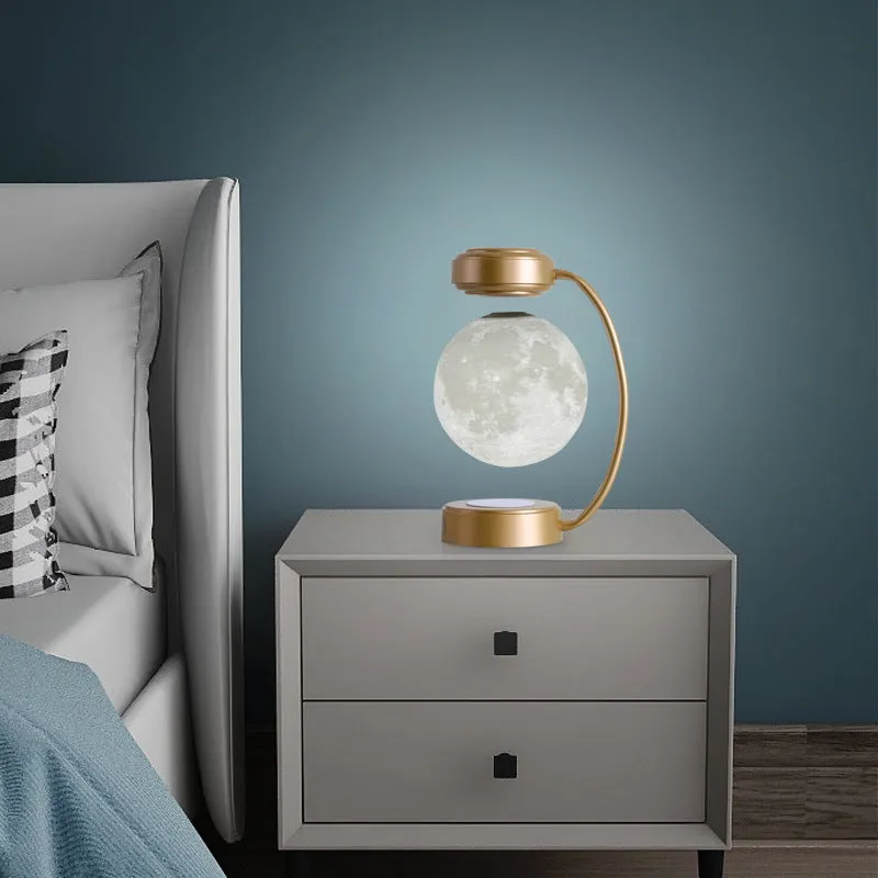 3D LED moon night light with magnetic levitation, floating ball, iron base, black finish on a desk
