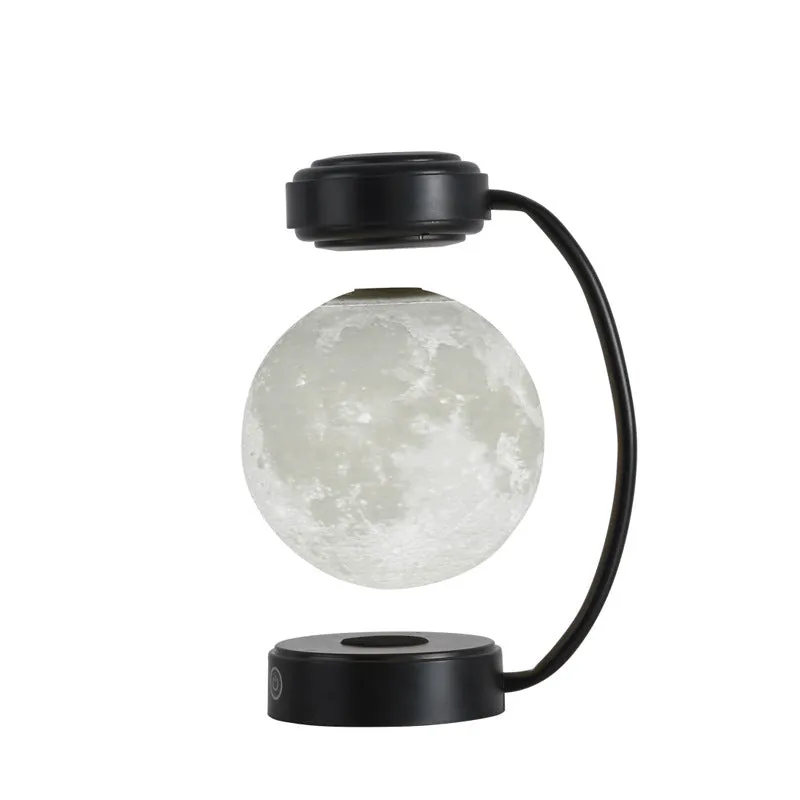 3D LED moon night light with magnetic levitation, floating ball, iron base, black finish on a desk