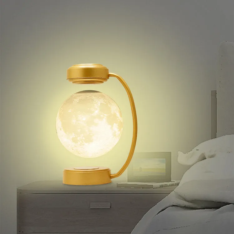3D LED moon night light with magnetic levitation, floating ball, iron base, black finish on a desk