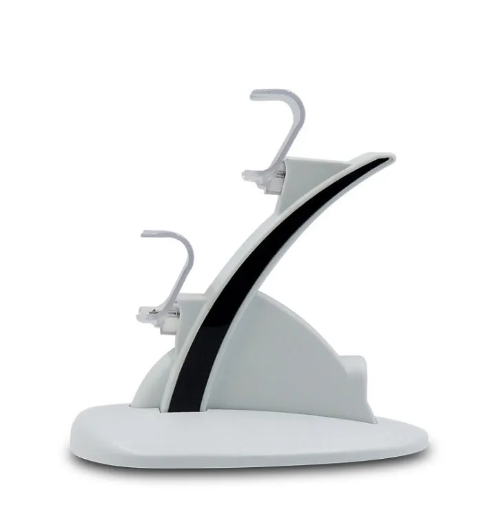 White dual PS4 controller charger with light-up docks showing blue glow and flashing modes